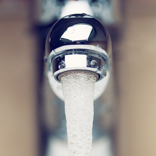 closeup of water pouring from a tap